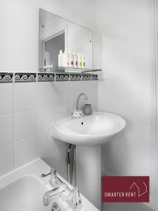 a white bathroom with a sink and a bath tub at Bracknell - 2 Bedroom Home With Garden & Parking in Easthampstead