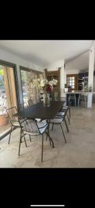 a dining room with a black table and chairs at Mer & Maquis in Bonifacio