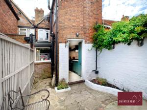 a door in a brick building with a bench at Henley-On-Thames - 2 Bedroom Cottage With Permit Parking Close By in Henley on Thames