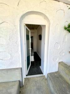 a doorway to a hallway with stairs in a building at MYKONOS VIBES AIRPORT STUDIOS AND APARTMENTS in Aggelika