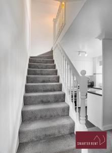 a staircase in a home with white walls at Farnborough - Lovely 1 Bedroom House in Blackwater