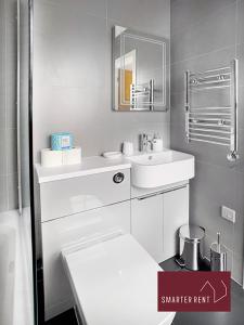 a white bathroom with a sink and a mirror at Eton, Windsor - 1 Bedroom First Floor Apartment - Parking in Eton