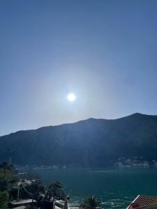 a view of a lake with the sun in the sky at Apartment Jovana in Kotor