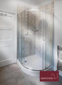 a shower with a glass door in a bathroom at Bray - Characterful 3 Bed House by the River in Bray