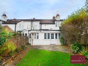 a white house with a garden in front of it at Bray - Characterful 3 Bed House by the River in Bray