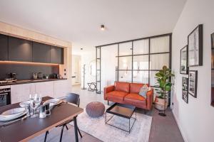 a living room with a couch and a table at Mono Design Apartments in Stuttgart