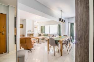 a living room and dining room with a table and chairs at The Urban Utopia at Glyfada in Athens