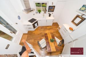 an overhead view of a kitchen and dining room with a table and chairs at The Gazebo in London