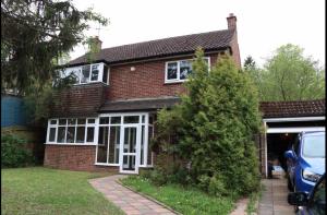 a house with a car parked in front of it at Wellesley, Central London Living in peaceful Suburb in Kenley