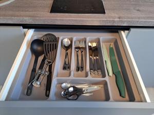 a drawer filled with utensils in a kitchen at Jaukūs apartamentai centre A. J. Greimo g. in Šiauliai