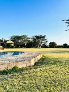 a small pool in the middle of a field at The Lookout in Naivasha