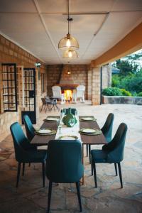 a patio with a table and chairs and a fireplace at The Lookout in Naivasha