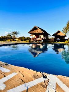 a resort with a pool of water in front of it at The Lookout in Naivasha