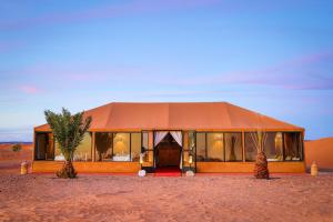 a building in the middle of the desert at Celia Desert Camp in Merzouga
