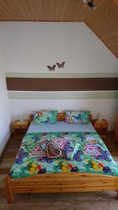 a bed with a colorful comforter on it in a room at Ferienwohnung Käfer in Rust