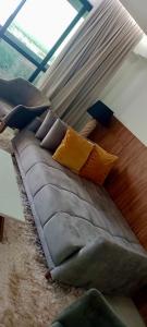 a couch with pillows on the floor in a room at INOVA FLAT conforto no Condominio Cosmopolitan in Palmas