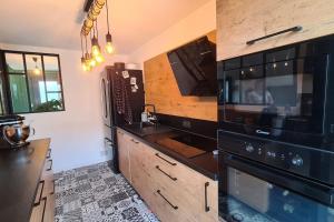 a kitchen with a black microwave and a sink at Saint Malo Agréable maison familiale in Saint Malo