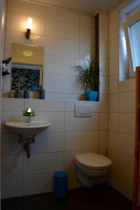 a bathroom with a toilet and a sink at Gästehaus Luna in Rust