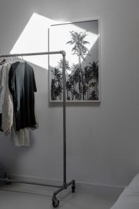 a lamp in a room with a picture of palm trees at PYLA: Nice creative studio 200 m from the beach in La Teste-de-Buch