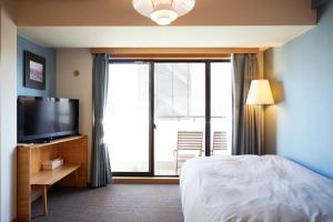 a hotel room with a bed and a television at Shibuya apartment SHINSEN in Tokyo