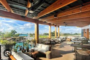 a large outdoor patio with couches and a pool at Blue Cottage at Casa Zoe in Charleston