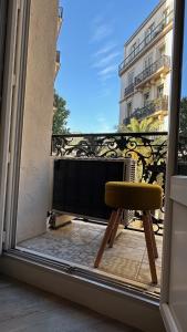 a chair sitting in front of a window at T2 Cosy Mirabeau in Toulon