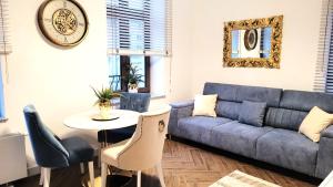 a living room with a couch and a table at APARTAMENT JARACZA 28/9 in Słupsk