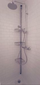 a shower with four metal shelves in a bathroom at Studio Oasis Narbonne Terrasse & Calme in Narbonne