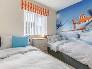 a bedroom with two beds and an airplane mural at 4 Bed in Westward Ho 85367 in Westward Ho