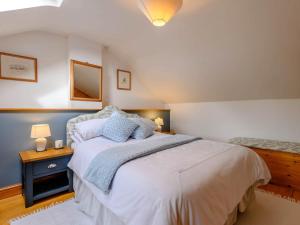 a bedroom with a large bed and a mirror at 1 Bed in Abergavenny BN092 in Llanvetherine