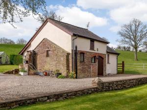 a small brick house with a gravel driveway at 1 Bed in Abergavenny BN092 in Llanvetherine