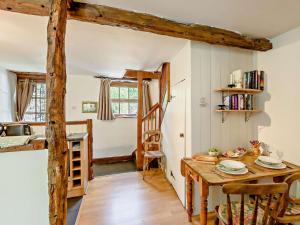 a kitchen with a wooden table and a dining room at 1 Bed in Crosthwaite LCC70 in Crosthwaite +9 photos