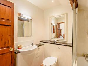 a bathroom with a sink and a toilet and a mirror at 1 Bed in Crosthwaite LCC70 in Crosthwaite