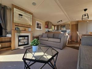 a living room with a couch and a table at Beautiful caravan near Edinburgh nr 14 in Port Seton