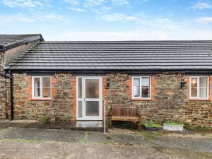 a brick house with a bench in front of it at 2 Bed in Barnstaple MOOSC in Chapelton