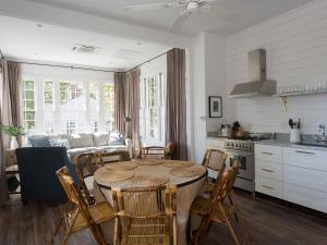 a kitchen and living room with a table and chairs at The Aviary at CasaZoe in Charleston