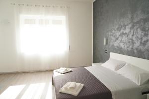 A bed or beds in a room at LA RESIDENZA DI ADAMO