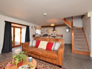 uma sala de estar com um sofá castanho e uma escada em 1 Bed in Taunton BARTC em West Monkton