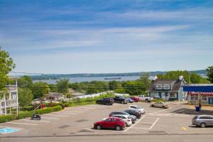a parking lot with cars parked in front of a building at Maison Grenier - Le Loft in Quebec City