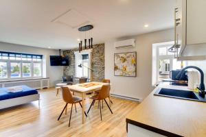 uma cozinha e sala de estar com mesa e cadeiras em Maison Grenier - Le Loft em Cidade de Quebec