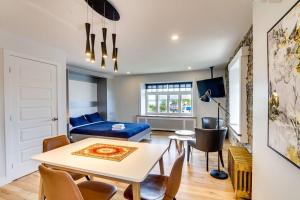 a living room with a table and a blue couch at Maison Grenier - Le Loft in Quebec City +9 photos