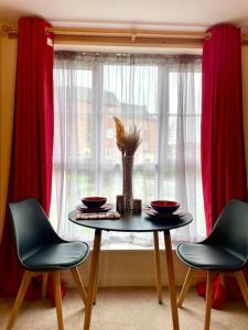 a table and two chairs in front of a window at 2bdroom city center luxury House in Birmingham