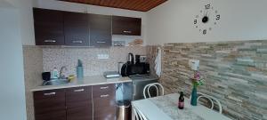 a kitchen with a sink and a counter top at Kis kuckó in Tapolca
