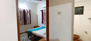 a bedroom with a mirror and a bed in a room at NUNES SEA WALK in Candolim