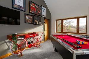 a billiard room with a pool table with a bike on it at Serene Riverside: 6BR Luxury Retreat in Curdridge in Curdridge
