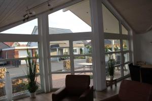 a room with a large window with a view of a patio at Ferienwohnung Skandianvian Sol in Zinnowitz