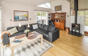 ein Wohnzimmer mit einem Sofa und einem Tisch in der Unterkunft 3 Bedroom Cozy Home In Brovst in Brovst