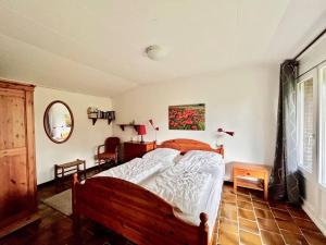 een slaapkamer met een groot bed en een spiegel bij Garnekuul 53 in Callantsoog