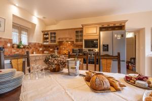 a kitchen with a table with bread on it at Maison coeur de Bastide-Piscine, ping pong & salle de jeux in Vianne