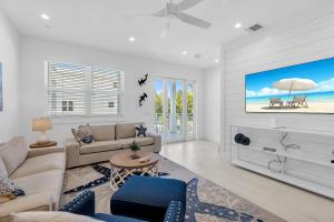 a living room with a couch and a tv at Peaceful Palms A2 in Islamorada